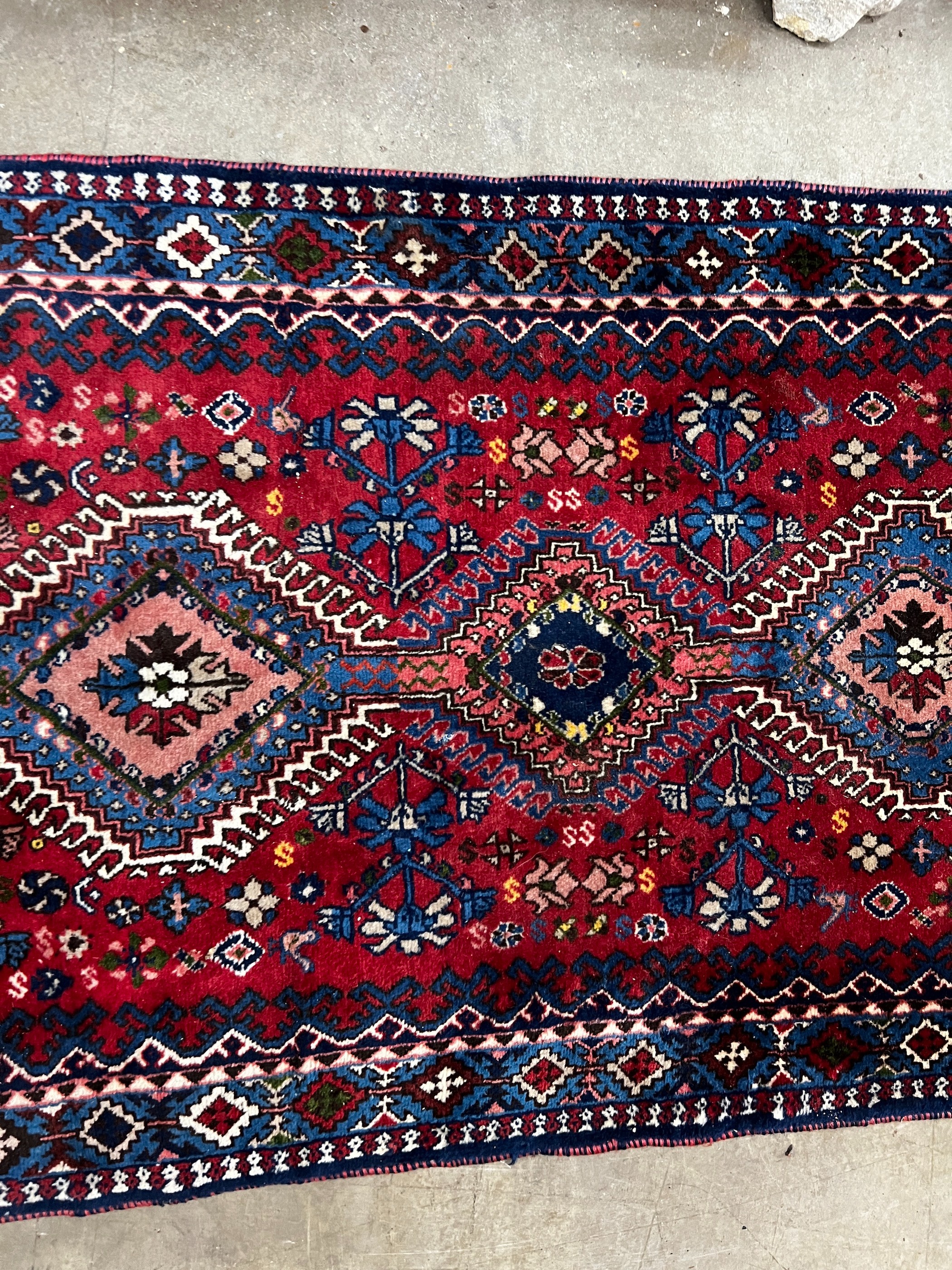 A Caucasian style red ground runner 200cm x 76cm